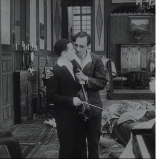 Image en noir et blanc. Un homme tient par l'épaule un jeune violoniste
